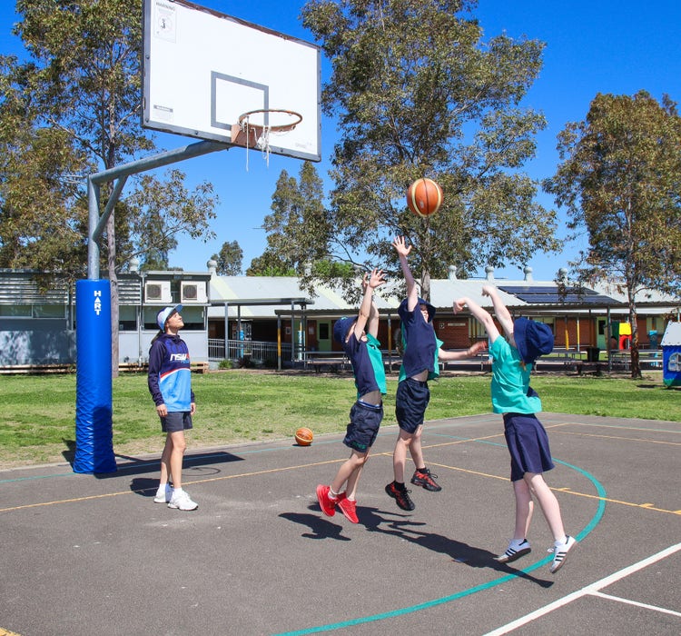 a teacher and 3 students playing basketball