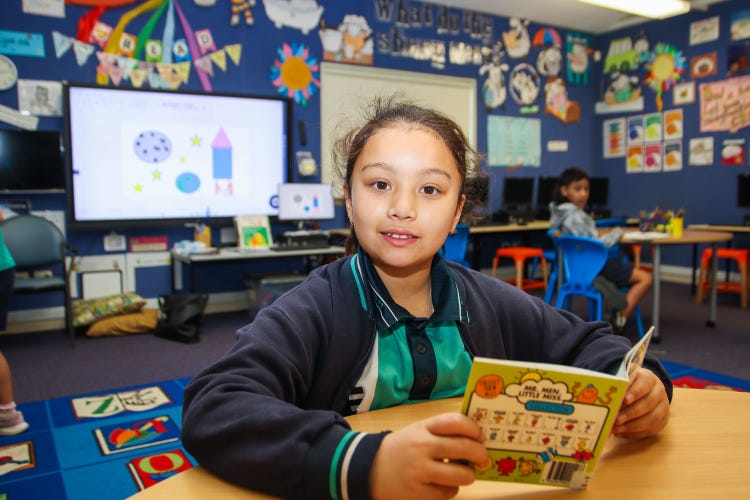 A girl reading a book in the library