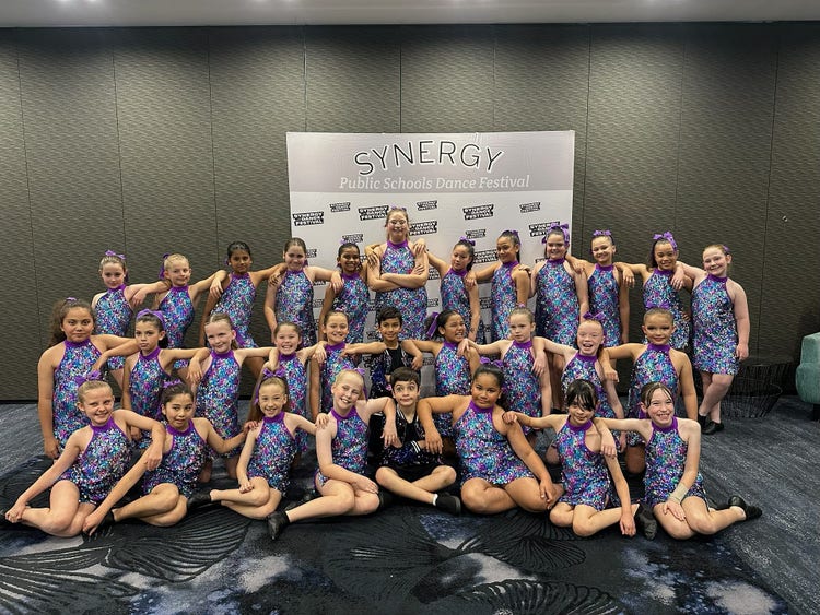 a group of students in dance costumes posing