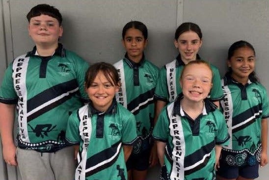 6 students wearing sport representative shirts