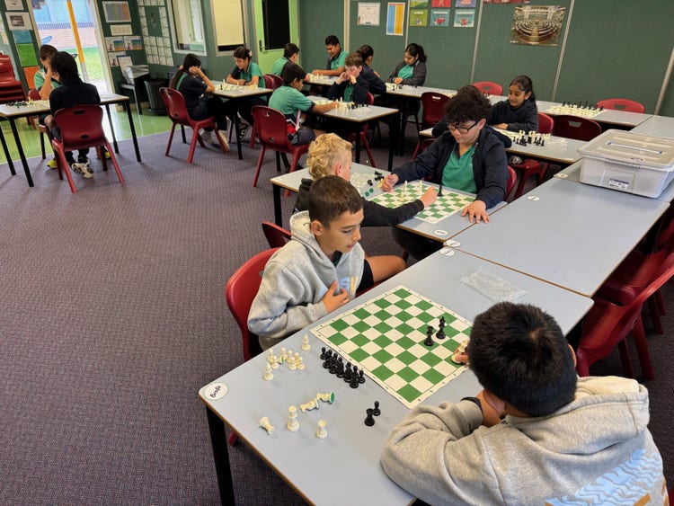 students playing chess in a classroom