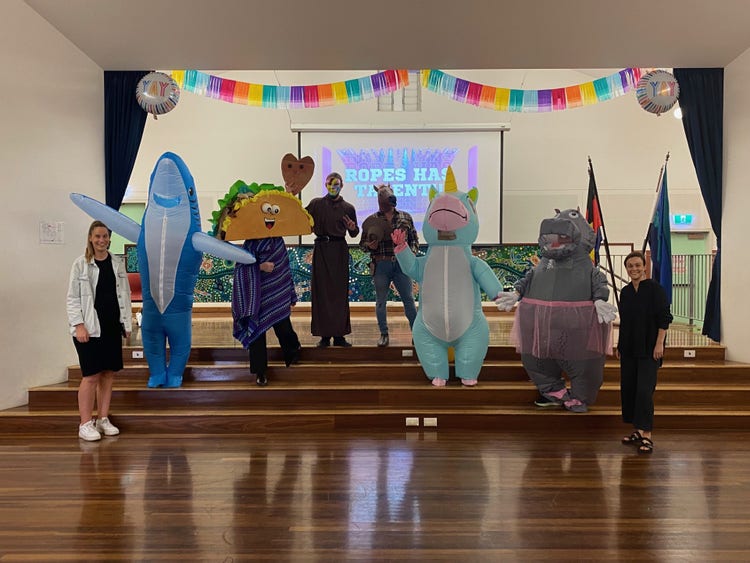 teachers dressed up in costumes standing on a stage