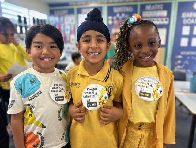 3 stdeunts weraing yellow holding rUOK badges
