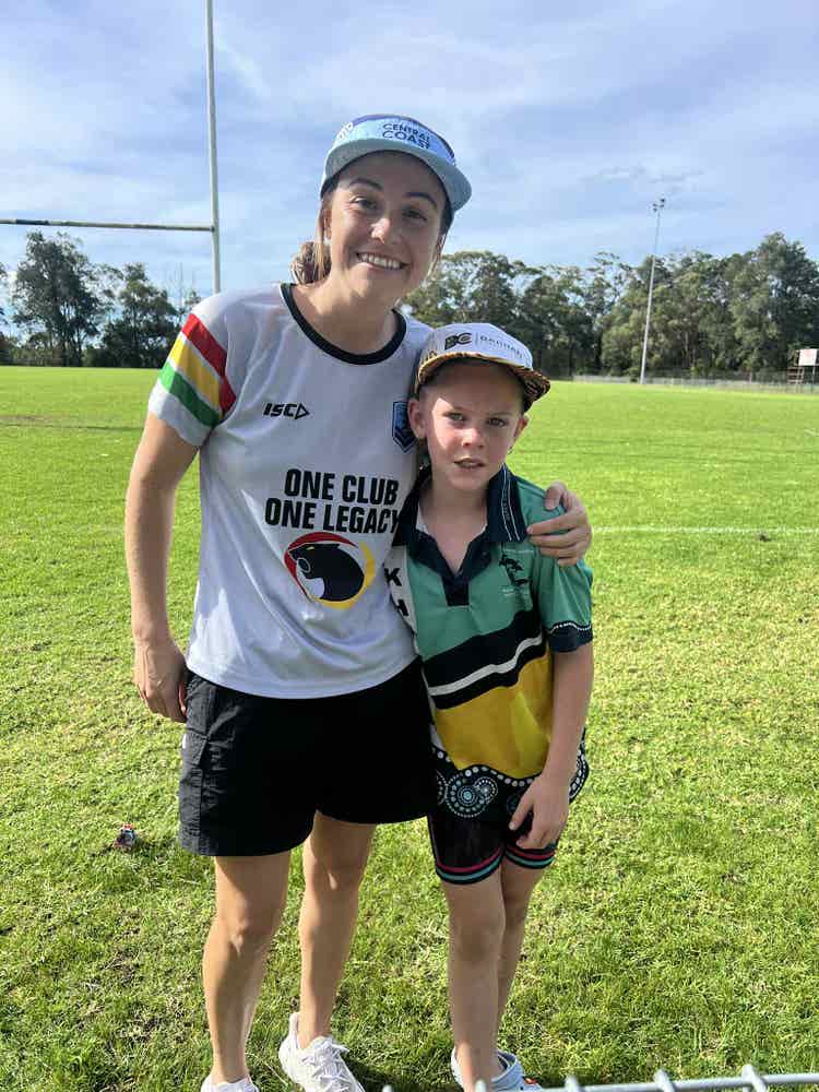 a teacher coach and a student standing outside