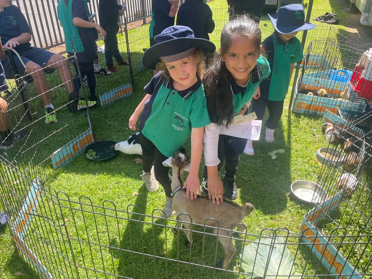 2 girls patting farm animals